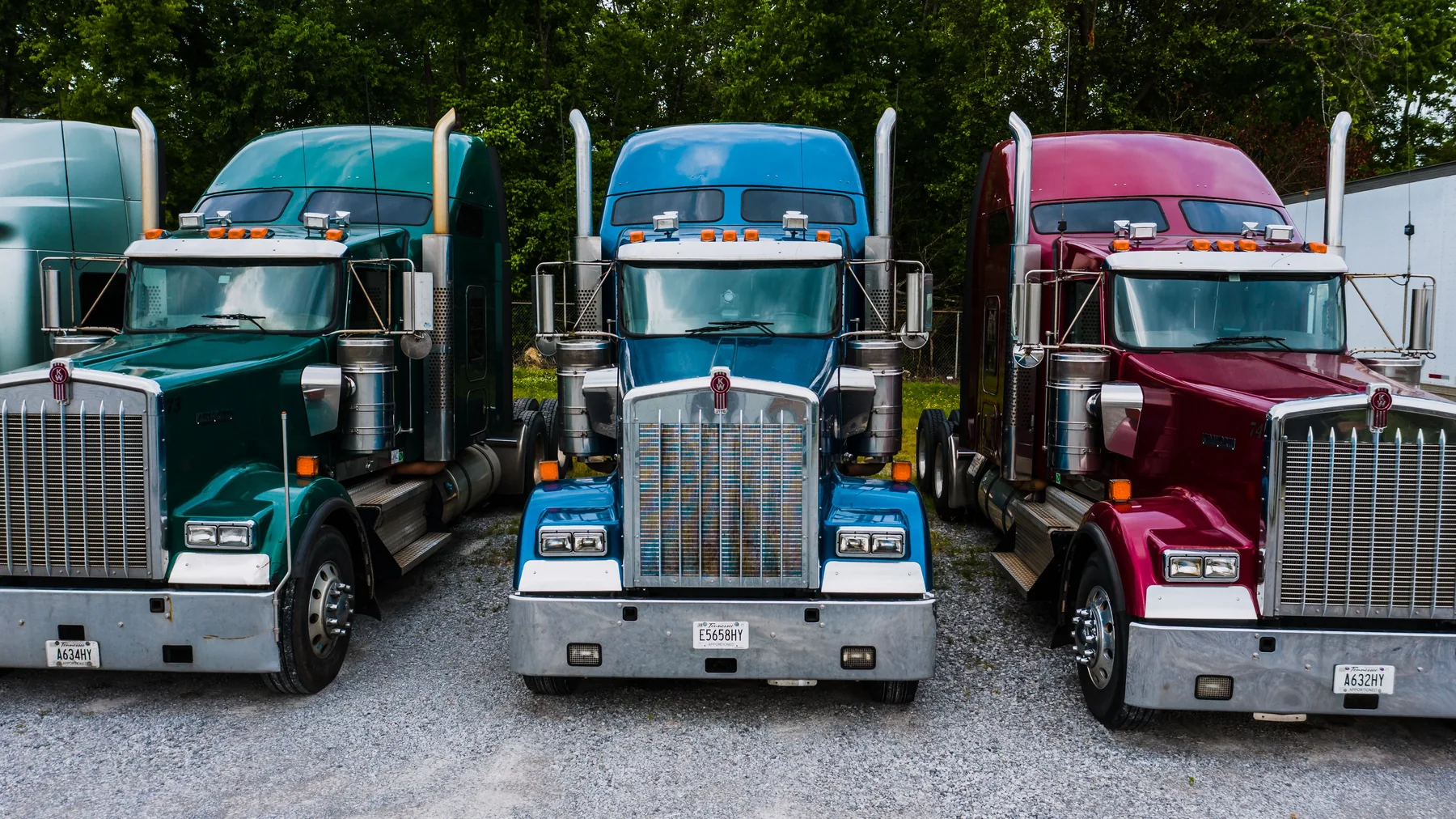 Conventional semi trucks parked side by side